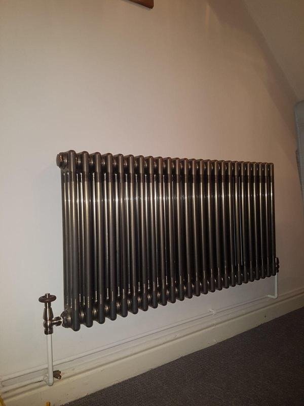Horizontal anthracite column radiator under a sloping ceiling